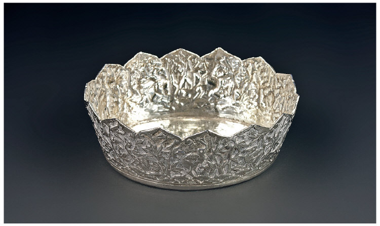 An Indian Crown Shaped Oval Silver Bowl. The sides richly worked in relief with birds amongst a