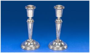 Silver Modern 20th Century Pair Of Candlesticks with tappered columns supported on a stepped