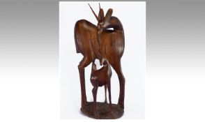 African Wooden Carving Of A Stylised Antelope With Two Calves. Height 21 Inches