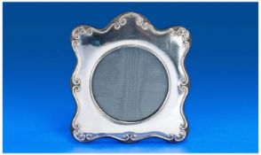 A Silver Shaped Photo Frame with ebony lacquered base. Britannia Silver Mark 95%. Hallmark London