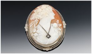 14ct White Gold Oval Framed Fine Shell Cameo Pendant/Brooch of a young woman wearing a diamond