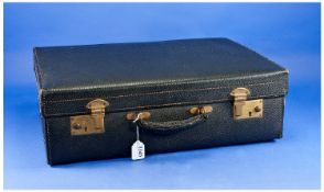 Small Black Leather Suitcase, circa 1950, with brass locks, brass hinges to back, the lid opening to