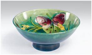 William Moorcroft Footed Bowl `Arum Lily` design on green/blue ground. Signed to base. 3.5 inches