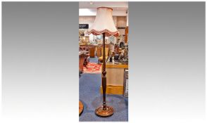 Tall Mahogany Standard Lamp, with pink shade, raised on turned and reeded column, standing on a