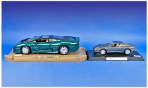 Two Model Cars, comprising a model Aston Martin DB7 complete with stand and a large Maisto 1992