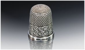 Small Silver Thimble, with webbed decoration to top and side with flower head detail to rim,