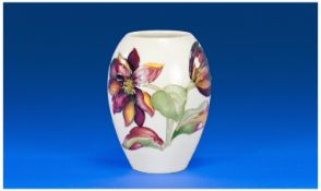 Moorcroft Vase `Clematis` design on white ground. Stands 4.25`` in height.