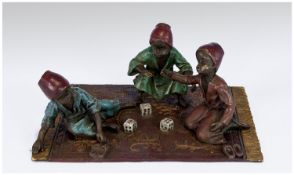 Vienna Bronze depicting three Moor boys seated/crouching in a rug playing dice. The underside is