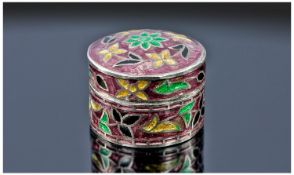 A Sterling Silver And Cloisonne Enamel Pill Box with pull-off lid. Enamelled with green, yellow