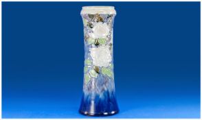 A Large Doulton Art Vase, with roses and leaf decoration on a blue running glass body. Markers