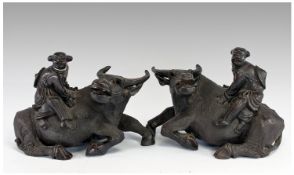 A Pair Of Large Chinese Carved Hardwood Reclining Water Buffaloes. Each mounted by a `Ming boy`