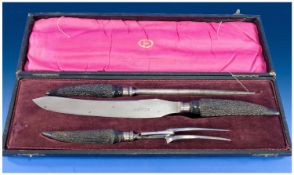A Boxed Three Piece Horn-Handled Carving Set by Christopher Johnson & co. of Sheffield. Stainless