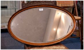 Early 20th Century Oak Framed Mirror, of oval form, moulded frame fitted with bevelled edge glass,