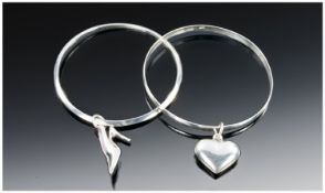 Two Silver Bangles One With A Heart Charm And The Other With A High Heel Shoe Charm.