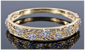 9ct Gold Hinged Bangle, The Front Set With 11 Clusters Of Tanzanite Each Set With a Central Round