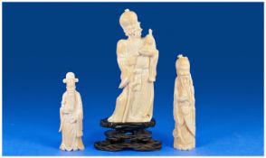 Three Carved Ivory Figures Depicting Elderly Men Of Widsom together with one carved hardwood stand.