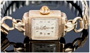 Avia Ladies Art Deco 9ct gold Cased Wrist Watch. Suspended on a gold plated expanding bracelet.