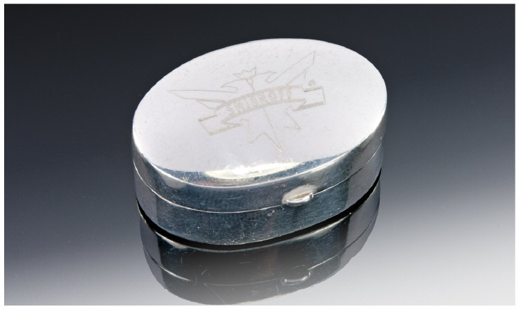 An Oval Silver Pill Box with hinged lid and extended clasp. Marked to the top `Smirnoff` and fully