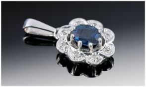 18ct White Gold Pendant, Set With A Central Sapphire, Surrounded By 8 Diamonds, Hallmarked To Bale.