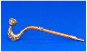 An Oriental Copper & Brass Pipe. The stem decorated with a raised brass mythical creature and each