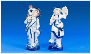German Early 20th Century Pair Of Blue & White Porcelain Figures, Each 7.25`` in height.