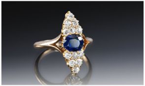 Victorian Ladies 15 Carat Gold Sapphire and Diamond Ring. The central sapphire flanked by 12 cushion