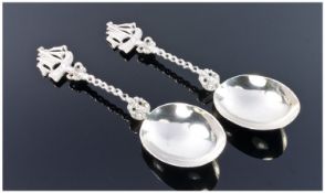 A Pair Of German Sterling Silver Spoons. Egg shaped bowls with rope twist handles surmounted by