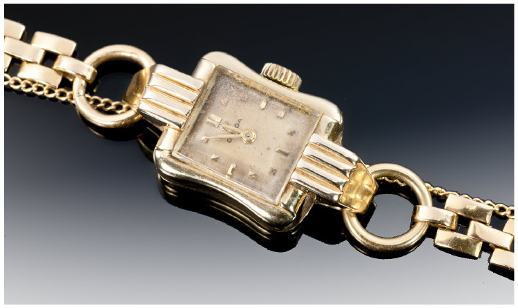Omega - Art Deco 18ct Gold Wrist Watch Supported on 18ct gold bracelet and safety chain. Small size.