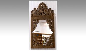 Elaborately Decorated Indian Wall Mirror, the wooden frame having bands of applied glass `sequins`