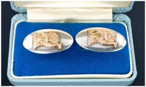 A Pair of Gentlemans Fine Silver And Gold Cufflinks, with raised 18ct gold figures of lamas on