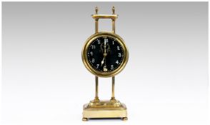Brass Mantel Clock, drum shaped, mounted on a pair of vertical brass columns held together at the