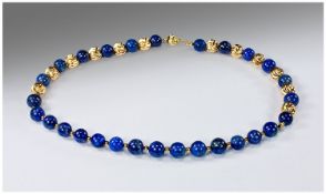 A Necklace Consisting of 28 Lapis Lazuli beads interspersed with gilded metal baubles. Unmarked.