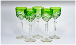 A Set Of Five Cut Glass Clear & Green Tall Drinking Glasses with tapered stems on a circular starcut