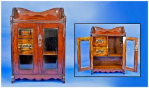 Early 20th Century Oak and Ash Smokers Cabinet, with shaped top, fitted with two glazed doors with