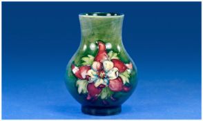 Moorcroft Small Vase. `Columbine` Design on green ground. Circa 1947. Label to base reads `potters