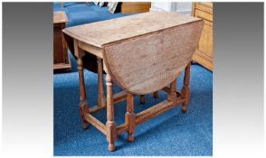 Oak Gateleg Table, of two leaf form, raised on turned legs, united by square stretchers, circa 1930,