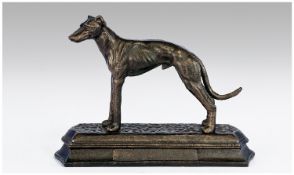 A Realistic Patinated Brass Model Of A Greyhound on an integral stepped plinth. Apparently