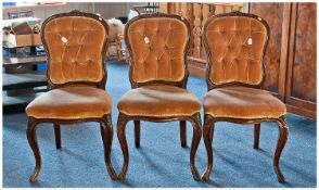 Three Mid 19th Century Walnut Parlour Chairs, in the French manner, with buttoned backs, overstuffed