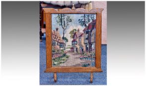 Oak Framed Fire Screen, circa 1900, shaped top rail and brass finial to centre, the stitched panel