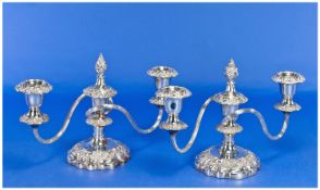 A Fine Pair Of Silver Plated Two Branch Candelabras with detachable nozzles and flame finials.