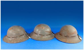 Three World War II Helmets.