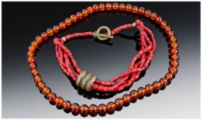 Two Necklaces, Set With Amber And Coral Coloured Beads.