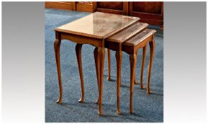 Nest of Three Tables, mid 20th century, with beech frames, the glass covered tops with walnut