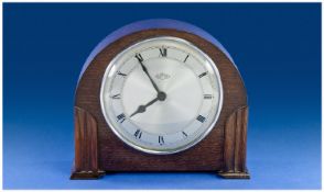 Garrards Art Deco Oak Cased Mantel Clock, with silvered dial and barelite back. 8 day lever