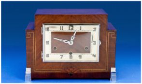 Art Deco Fine Walnut Cased Mantel Clock with 8 day chiming and striking movement, on eight gongs.