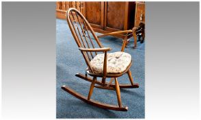 Small Ercol Rocking Chair, in beech and elm, with hooped back, rodded supports, arms, erm seat and