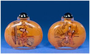 Pair of Snuff Bottles with oriental scenes to front.