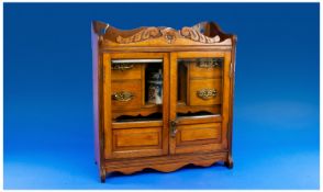 Edwardian Golden Oak Smokers Cabinet. The front two class panel doors opens to reveal 4 draws and