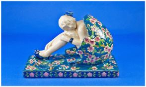 An Early 20th Century Model of a 1920`s Maiden seated in an egg shaped garden seat and on an