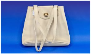 Parallele Beige Leather Trapeze Bag, long double straps, gold colour decoration to flap closure,